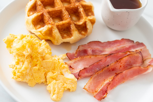 scrambled egg with bacon and waffle for breakfast
